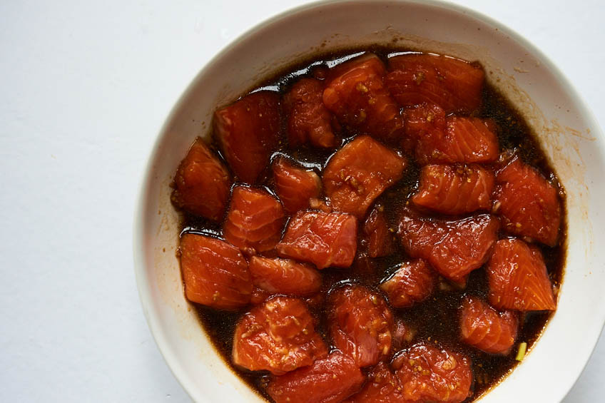 Salmon pieces marinating in a bowl