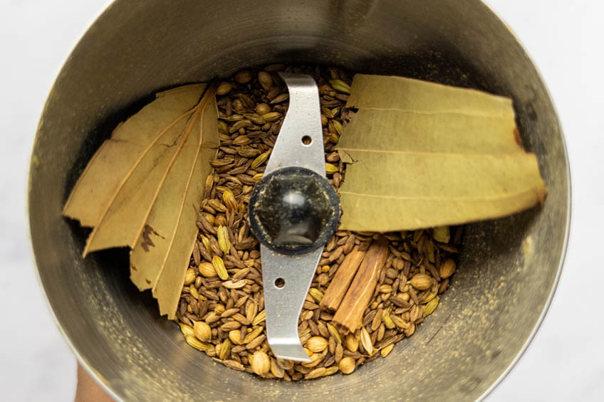 Dry spices for masala in a coffee grinder