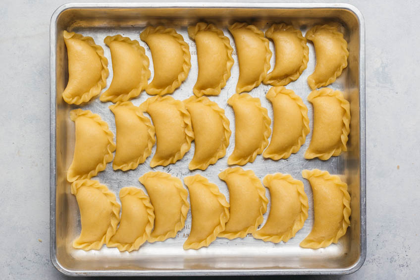 Uncooked sweet peanut dumplings on a baking tray