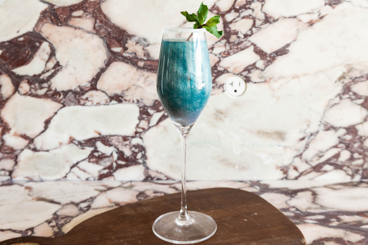 Glittery blue lagoon cocktail, ready to serve