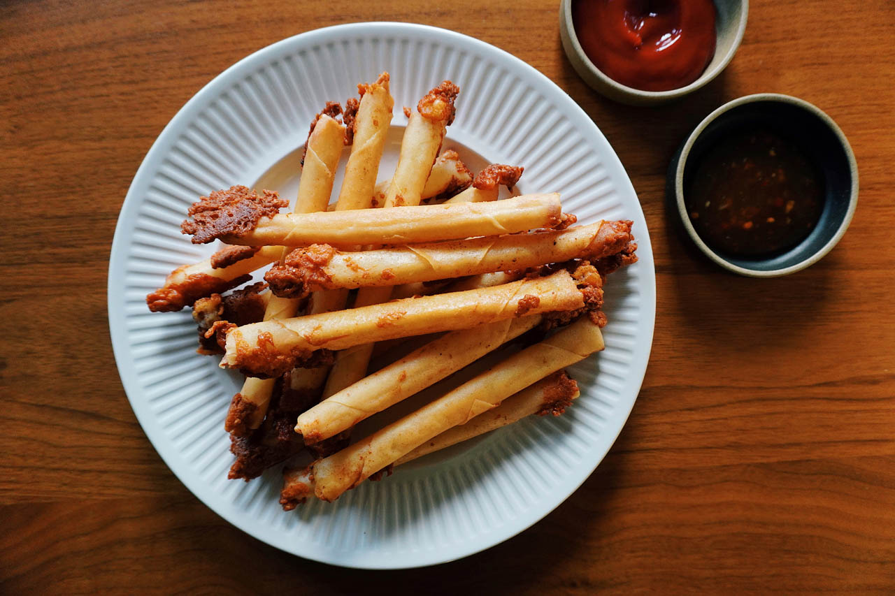 Cheese lumpia with banana ketchup and sweet and sour sauce for dipping