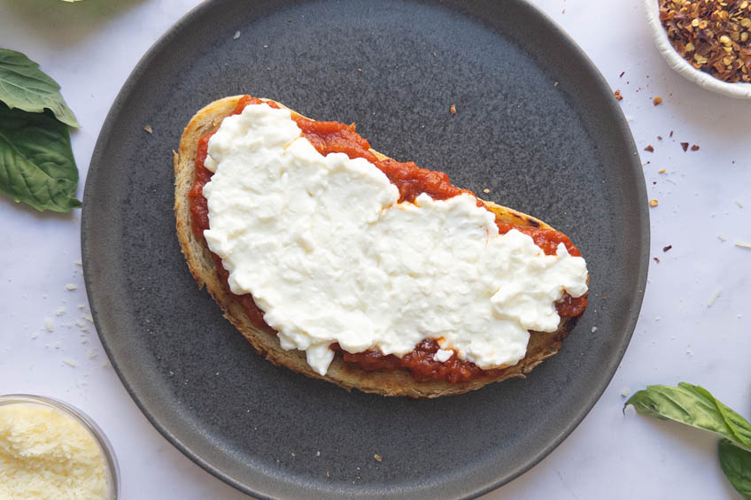 Sourdough toast topped with tomato sauce and cottage cheese for Cottage Cheese Pizza Toast
