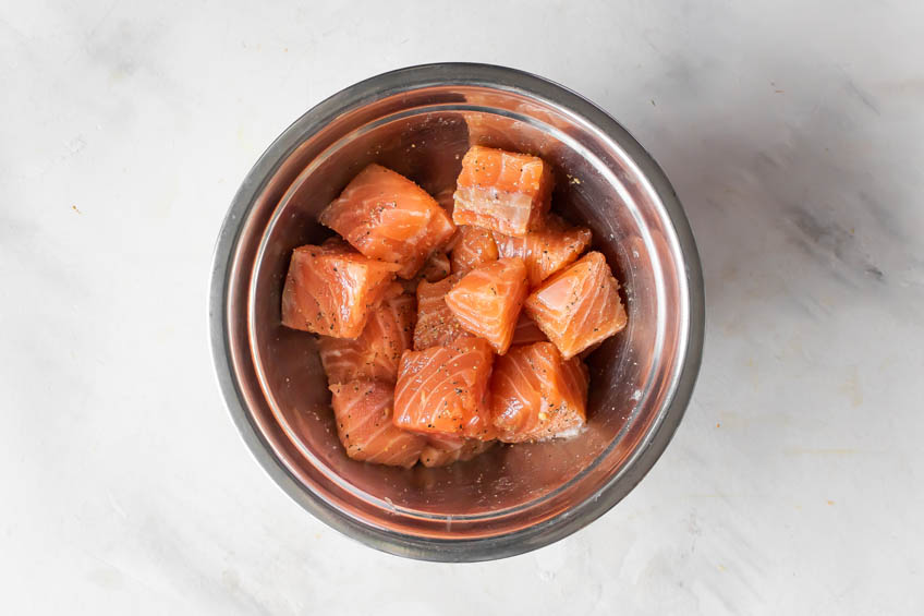 Raw salmon pieces in a bowl