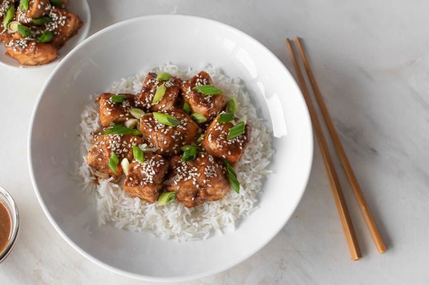 Air fryer maple tahini salmon bites on a bed of rice