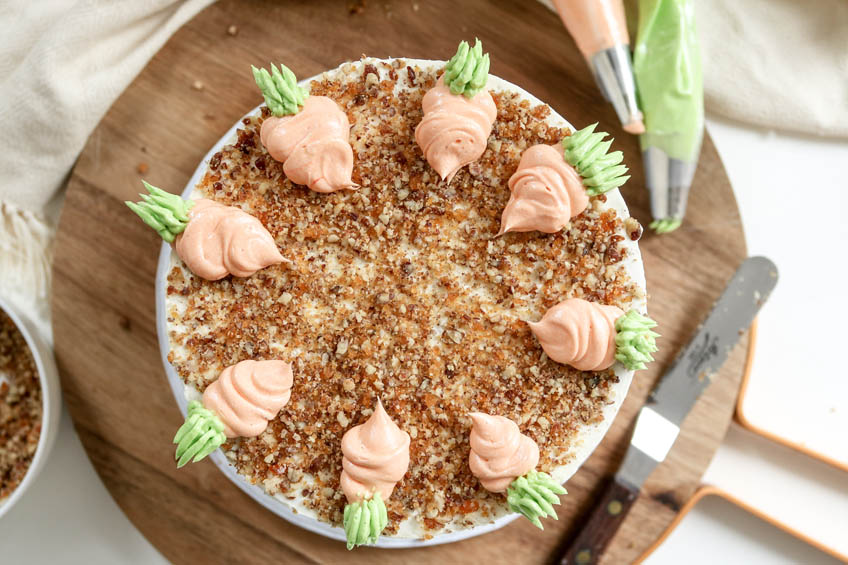 Brown butter carrot cake topped with frosting carrots