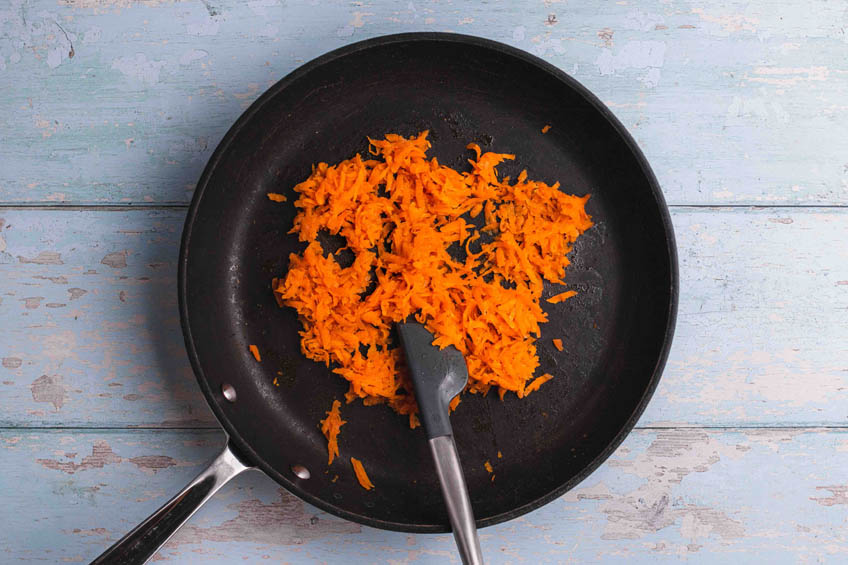 Grated carrots in a small frying pan