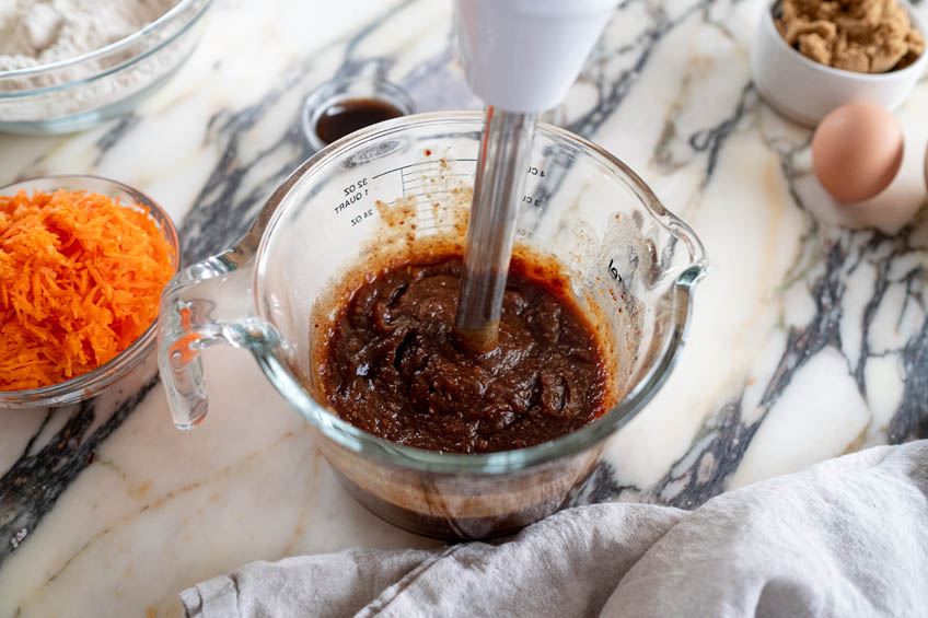 Dates, water and baking soda being blended with an immersion blender
