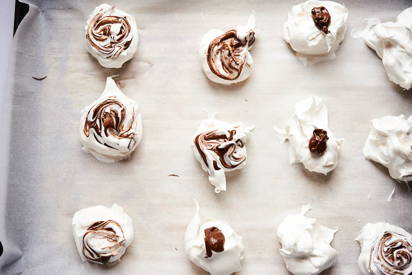Unbaked Passover meringues on a parchment lined baking sheet