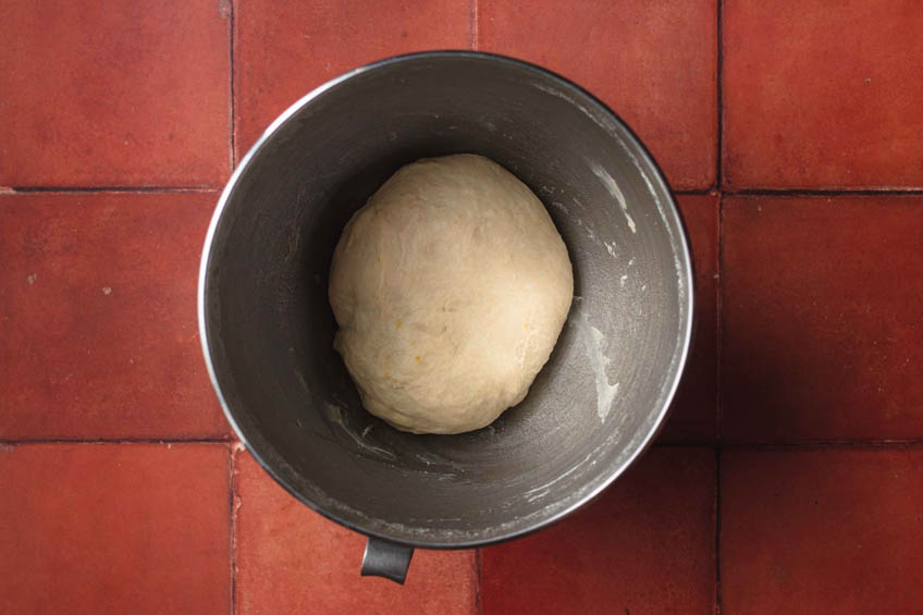 Unrisen dough for vegan malasadas in a mixing bowl