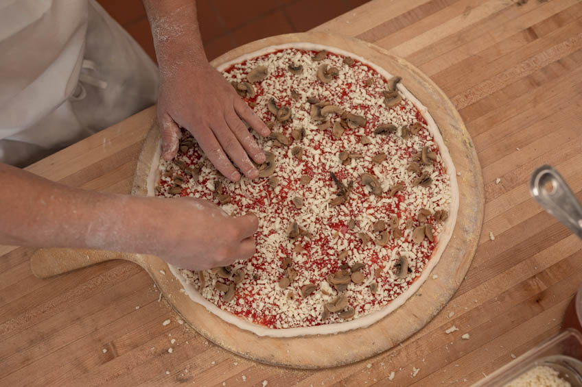 A Windsor pizza being prepped