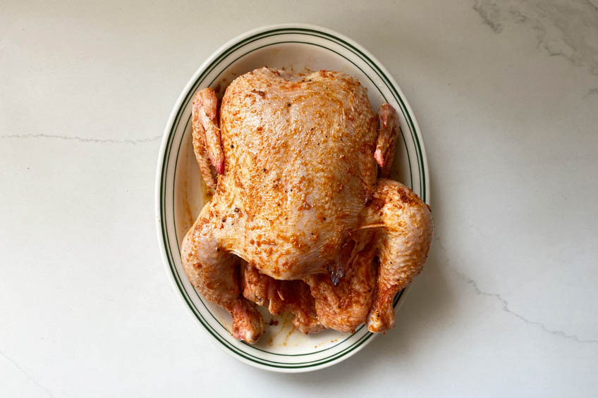A seasoned chicken on a plate