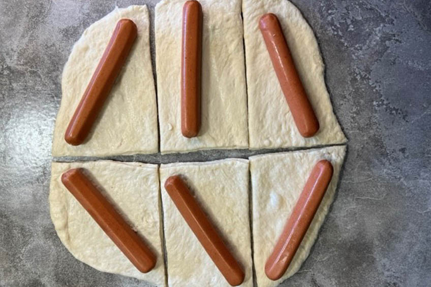 Hotdogs on bannock dough, ready to be rolled up