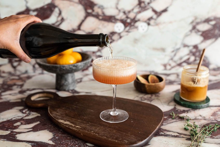 Beyonce-inspired Pure/Honey cocktail being topped with prosecco