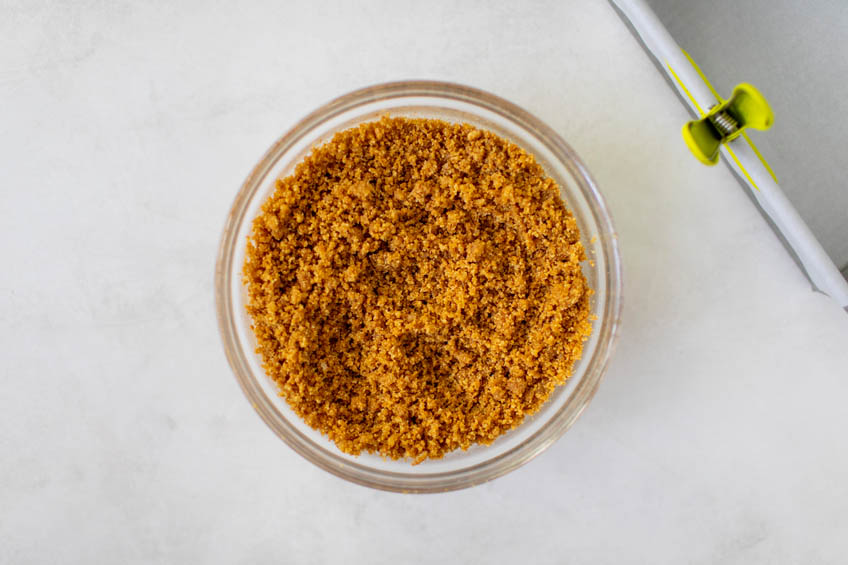 Graham cracker crust ingredients in a small bowl