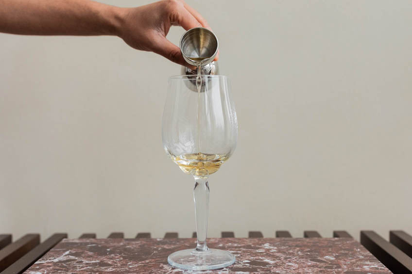 St-Germain being added to a wine glass