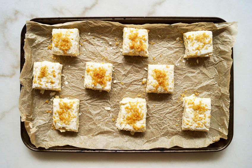 Unbaked shortcakes on a parchment-lined baking sheet