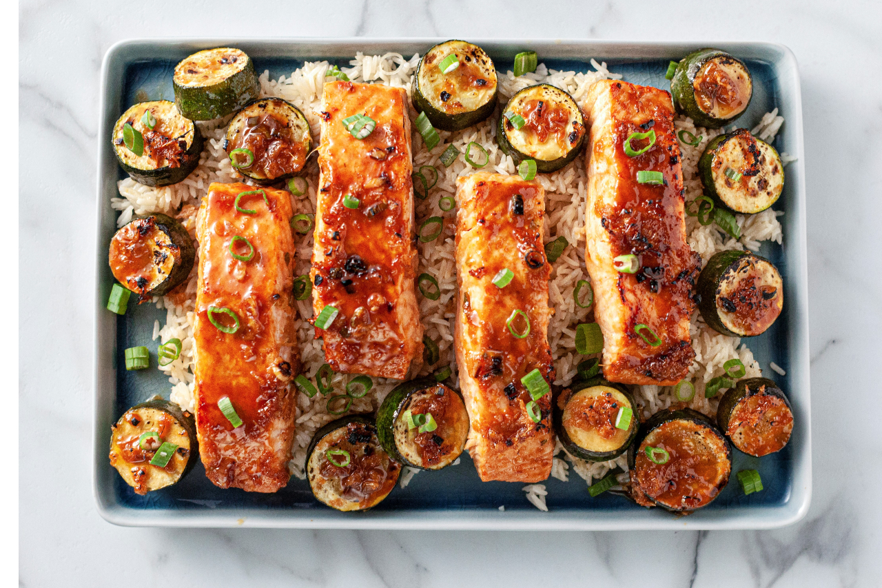 An overhead shot of Ree Drummond's sriracha maple salmon steaks with grilled zucchini