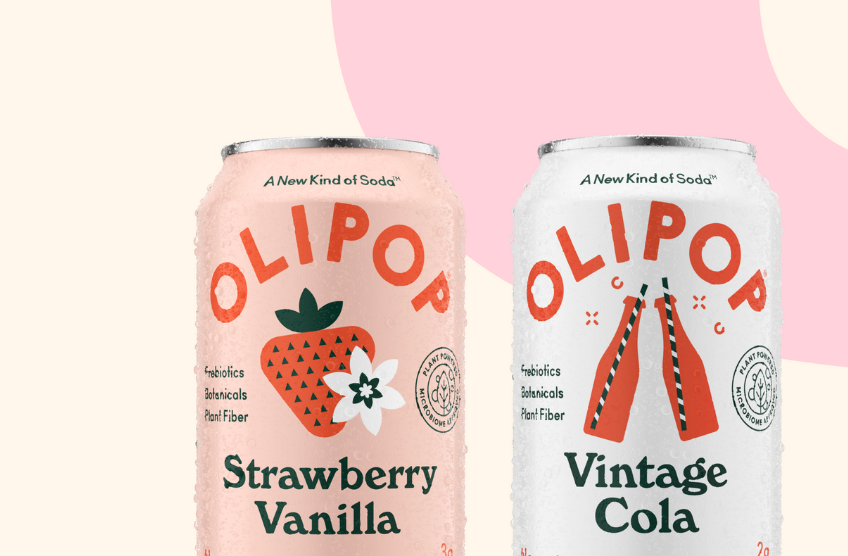 Two cans of Olipop soda in flavours strawberry vanilla and vintage cola