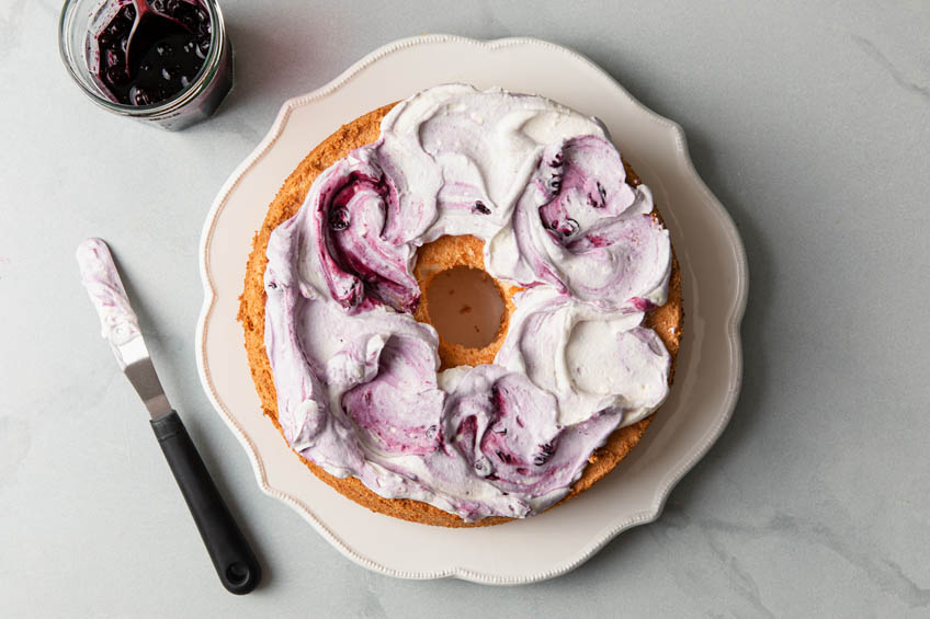 Angel food cake frosted with blueberry frosting