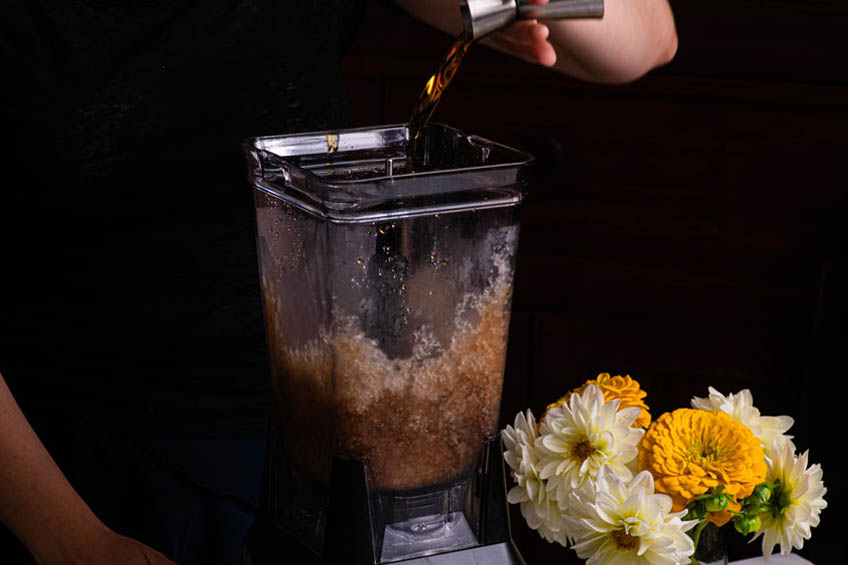 Bourbon being poured into a blender