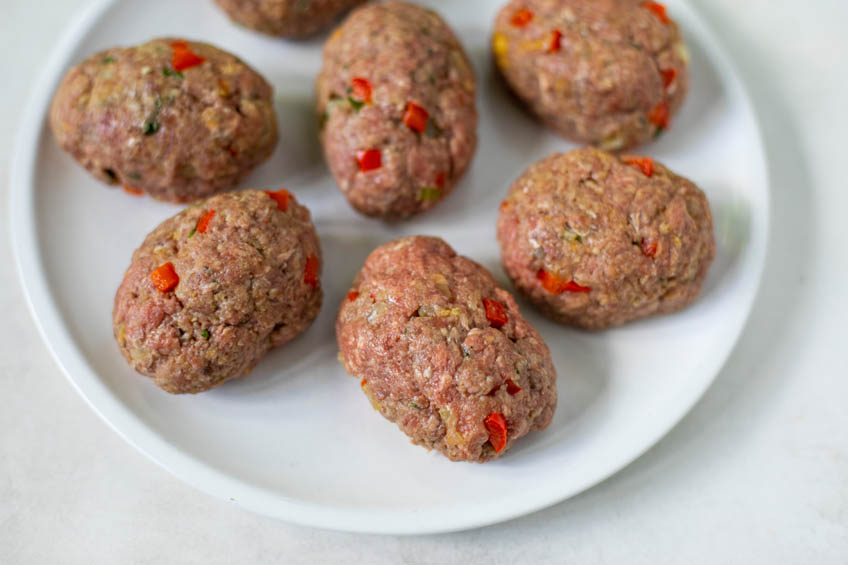Raw mini meat loaves on a plate