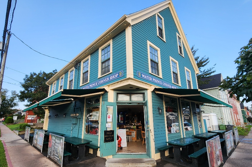 The exterior of the Water Prince Corner Shop in Charlottetown, Prince Edward Island, with light blue siding and white trim.