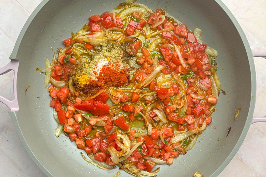 Tomatoes and spices added to pan