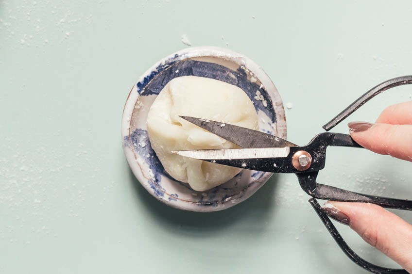 Mochi being pinched and sealed with scissors