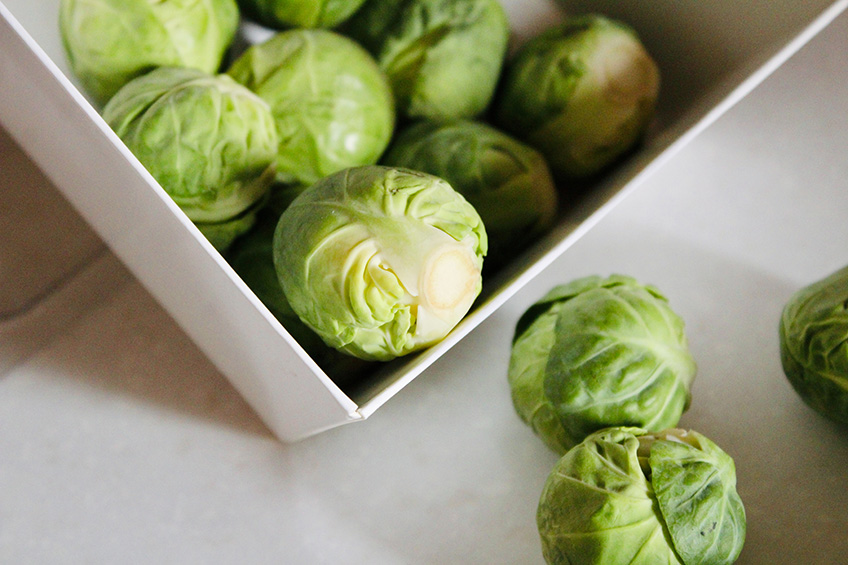 Close-up of Brussels sprouts in a white dish.