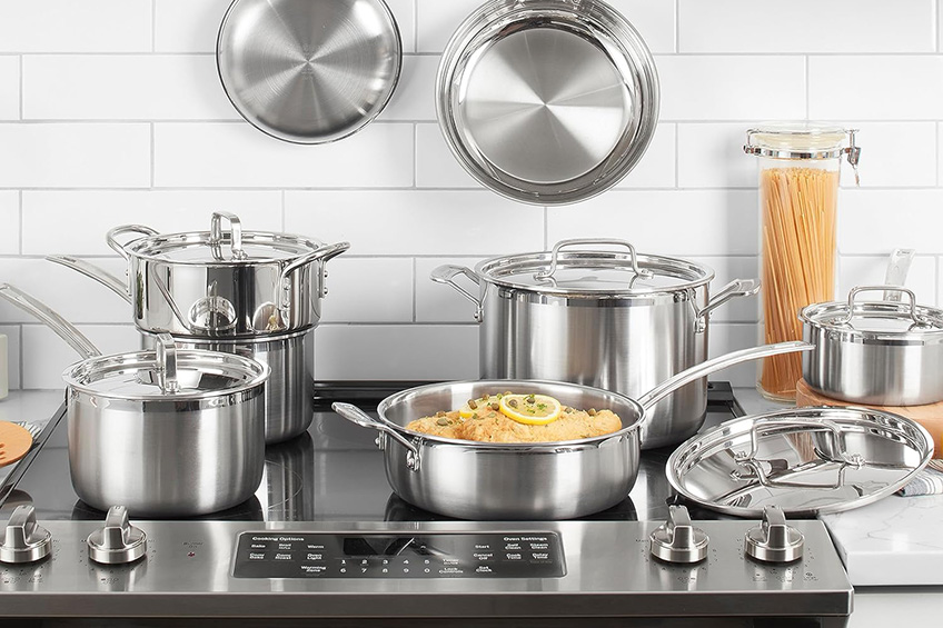 Cuisinart multiclad pro stainless steel 12-piece cookware set on a stovetop with pasta visible in one of the pots.