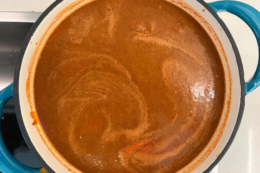 Overhead shot of an Azteca soup in a blue cast iron soup pot