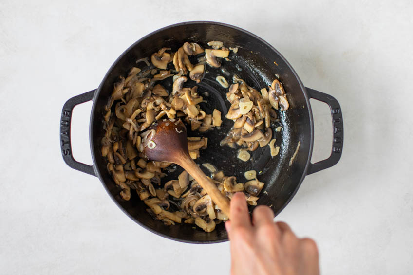 Mushrooms and aromatics in a saute pan