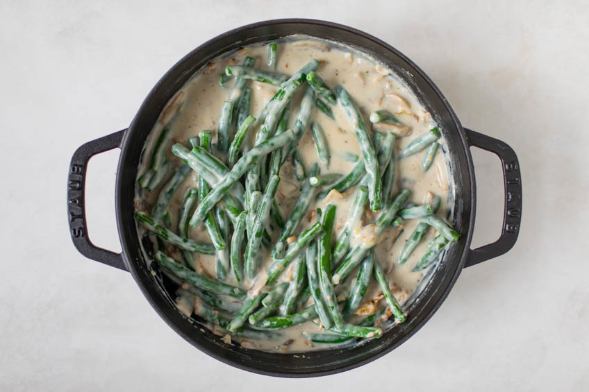 Green beans, cheese and crispy onions added to pan
