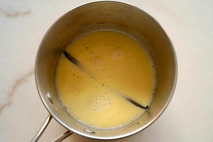 Butter, milk and vanilla beans in a saucepan