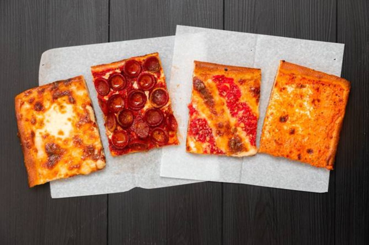 Four slices of square Detroit-style pizza from Prince Street Pizza in New York