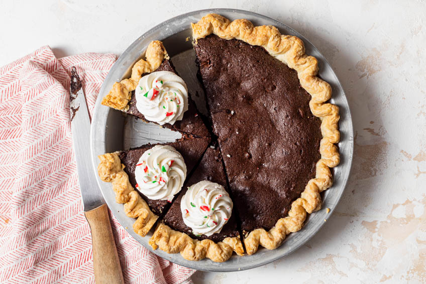 Brownie pie topped with peppermint whipped cream