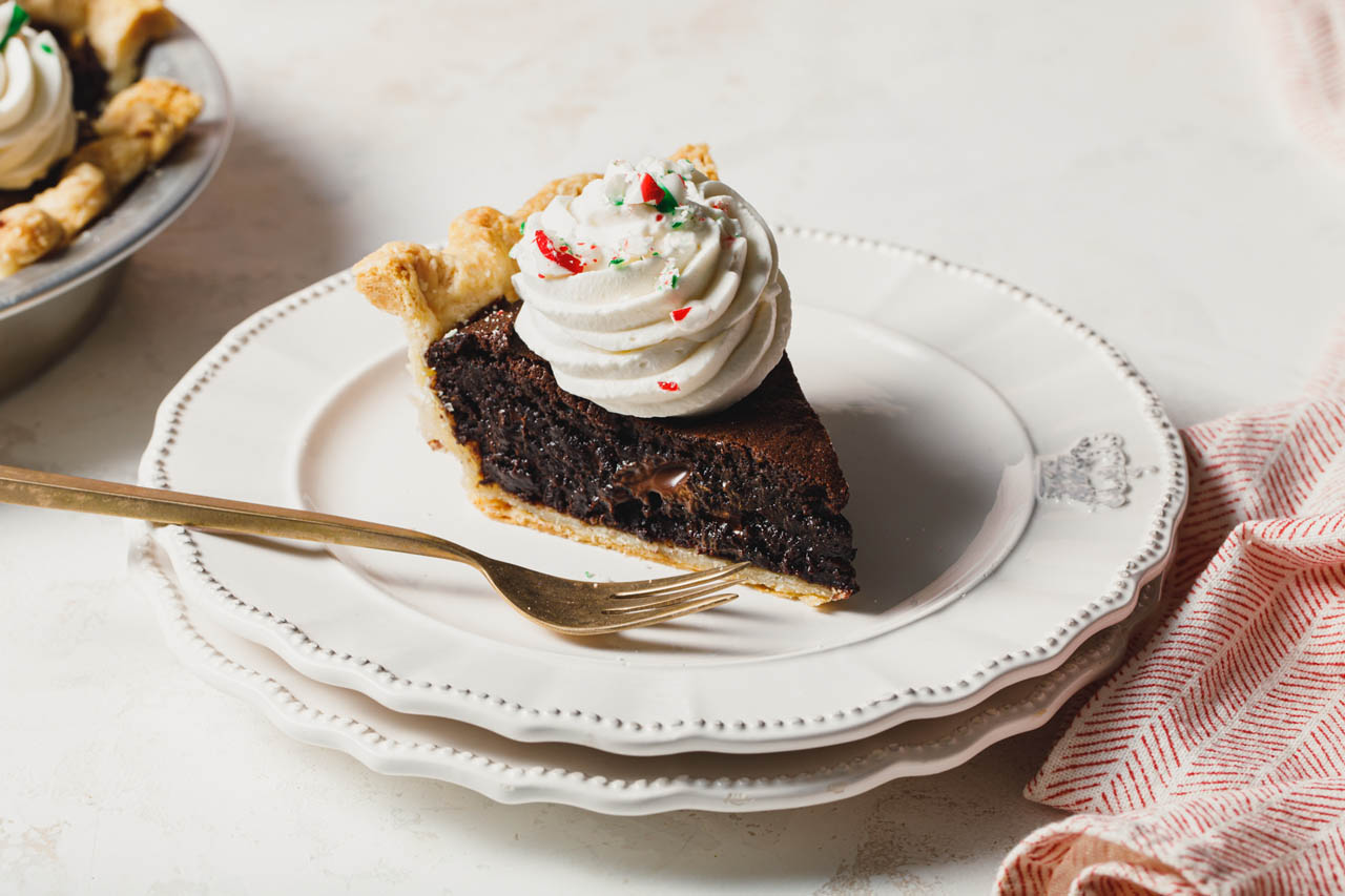 A slice of Brownie Pie with Peppermint Whipped Cream