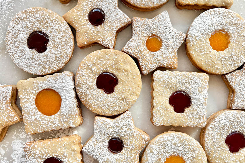 A closeup on Jam-Filled Spiced Linzer Cookies