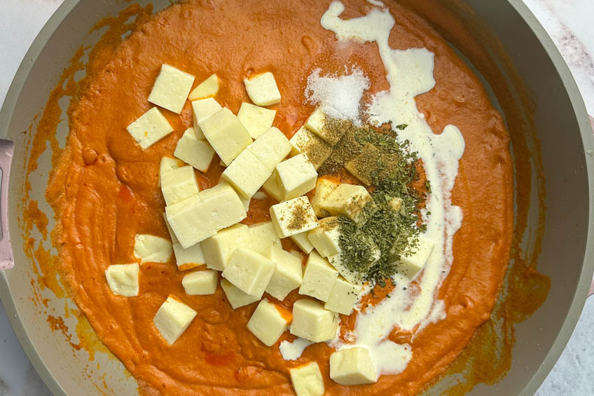 Paneer, spices and cream added to pan
