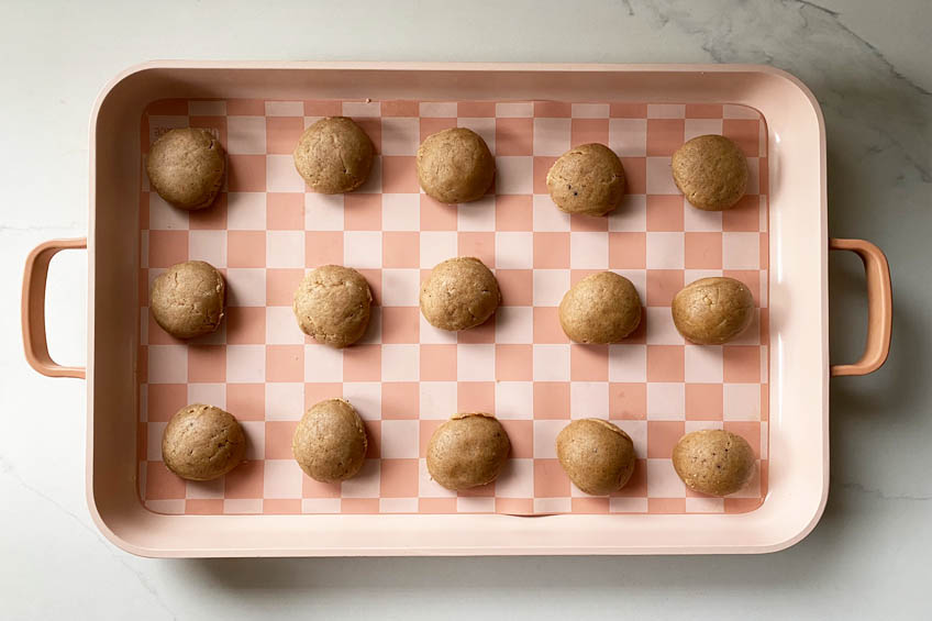 Taylor Swift chai cookie dough balls on a lined baking sheet
