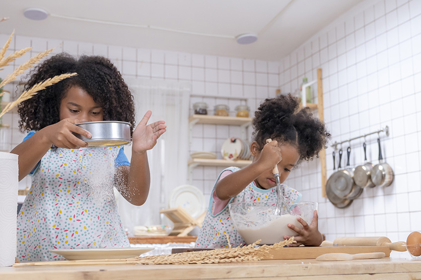 Two children are having fun in the kitchen