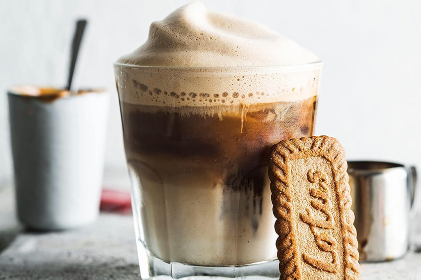 Lotus Biscoff biscuit against a foamy beverage