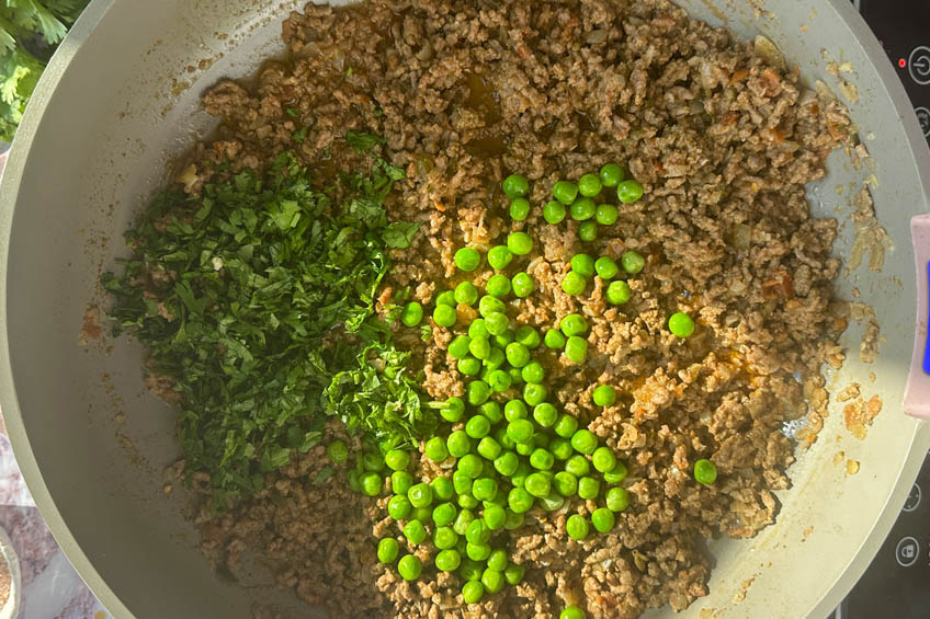 Peas and cilantro added to pan