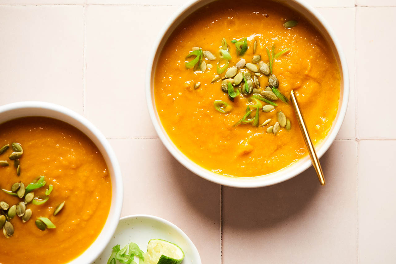 Two bowls of Miso Ginger Carrot and Sweet Potato Soup