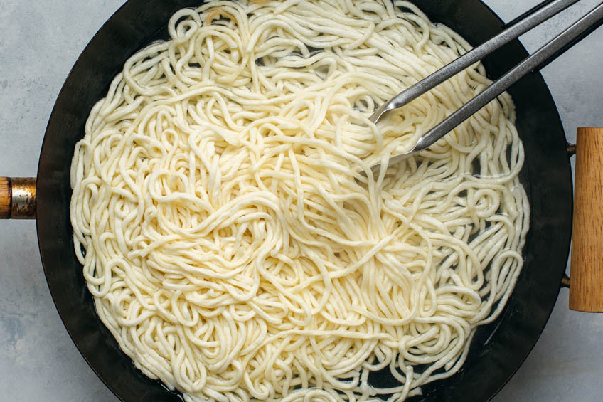 Yee mein noodles blanching in wok