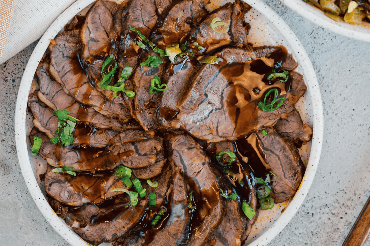Braised five spice beef on a white plate