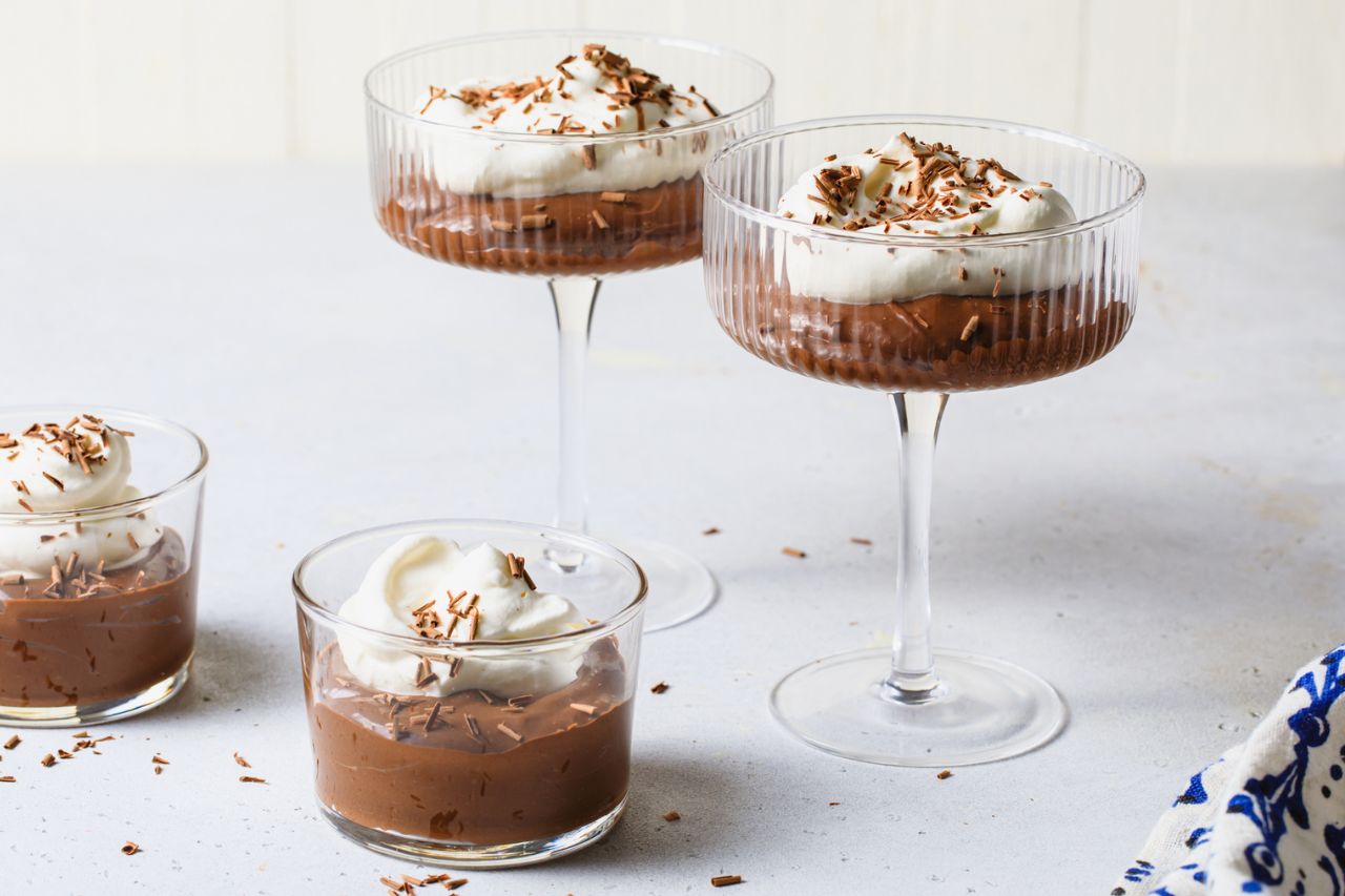Earl Grey chocolate pudding topped with whipped cream and chocolate shavings