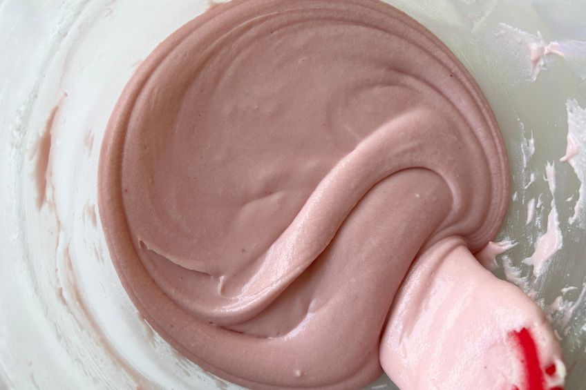 Raspberry cream cheese frosting in a mixing bowl