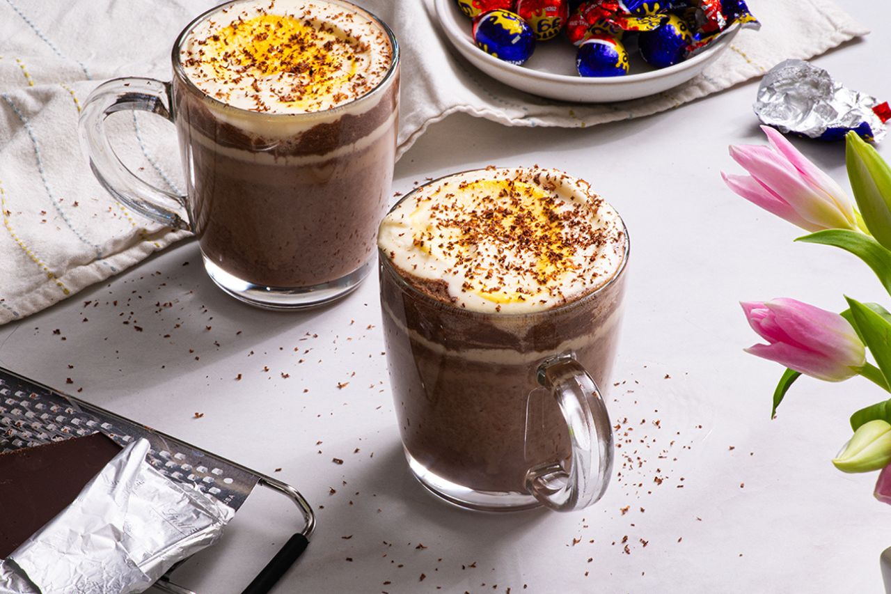Two creme egg mochas topped with chocolate flakes