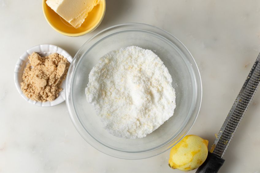 Sugar and lemon zest combined in a bowl